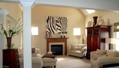 This space shows off a fireplace and vaulted ceili