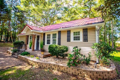 View of front of property with a metal roof and covered porch