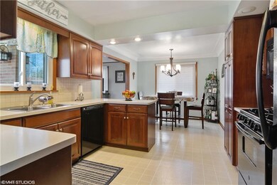 Large eat in kitchen with cherry wood cabinets and pantry.