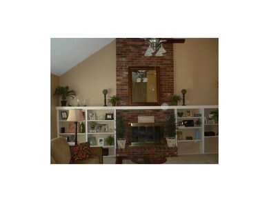 Brick fireplace and built-in shelves in the living