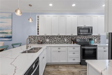 Kitchen featuring sink, hanging light fixtures, wh
