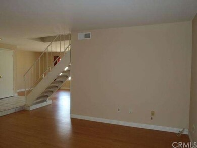 Living room and view to coat closet.