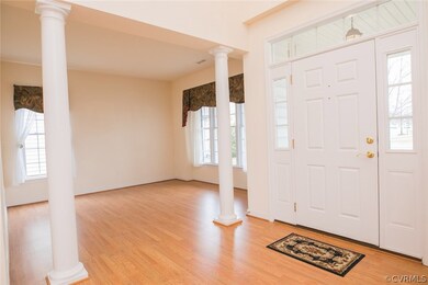Two story foyer is open to dining room