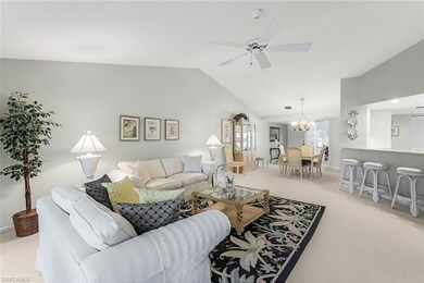 Carpeted living room featuring ceiling fan with no