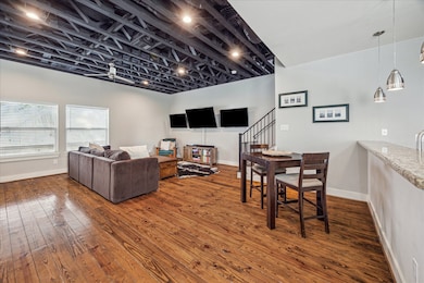 This open-concept living space features rustic har