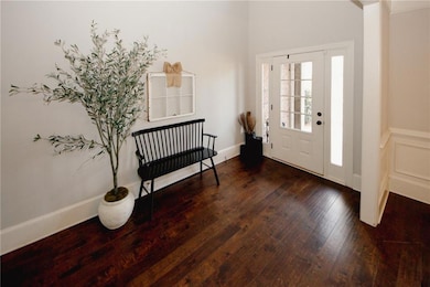 Entryway with baseboards and wood-type flooring