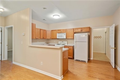 Kitchen featuring light wood-type flooring, light 