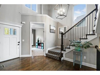 Two story foyer with dramatic open stairs.