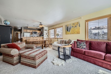 Living room with carpet floors and a ceiling fan