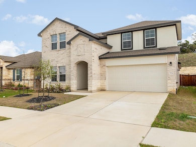 Traditional-style house featuring concrete drivew