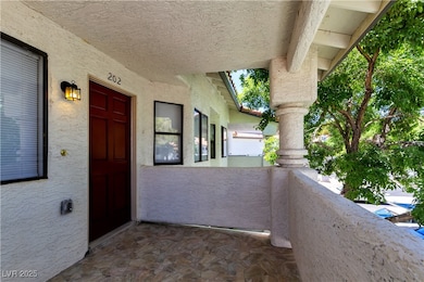 View of exterior entry with a balcony and stucco s