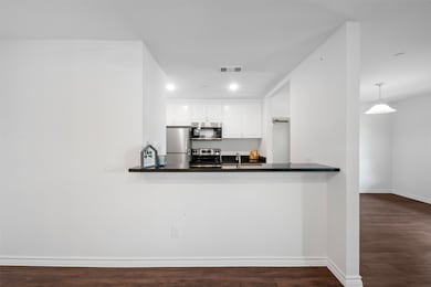 A stylish breakfast bar seamlessly connects the ki