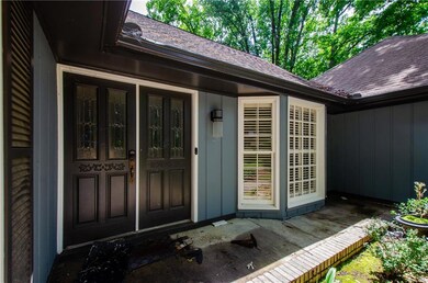 Doorway to property featuring roof with shingles