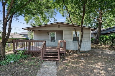 View of front of property with a wooden deck