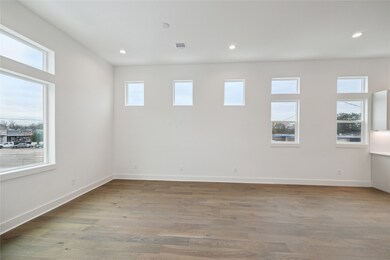 Bright and spacious living area featuring large wi