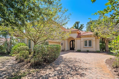 Mediterranean / spanish-style home featuring decorative driveway, stucco siding, and a tile roof