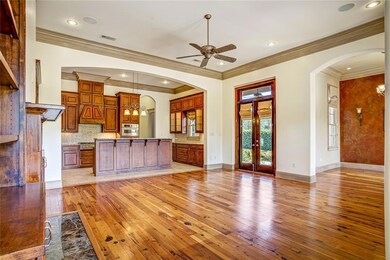 View from foyer of living room, kitchen and dining