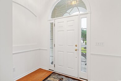 Entrance foyer featuring hardwood / wood-style flo