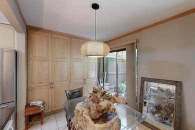 Dining area with wall of storage and door to huge 