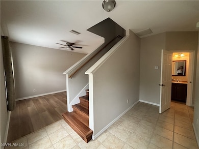 Stairway with tile patterned flooring and a ceilin