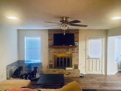 Living area with visible vents, a brick fireplace,