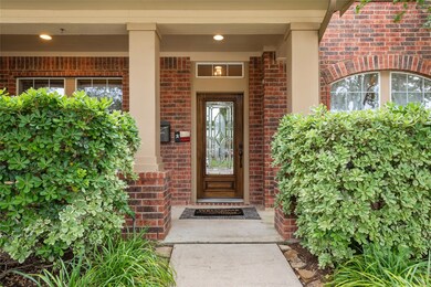 This David Weekley home's charm is heightened by the front porch with columns painted to match the trim of the home. Lush landscaping was selected for its evergreen appearance and low maintenance requirements. Let the 10-zone sprinkler system do the work while you enjoy your morning coffee on the porch.