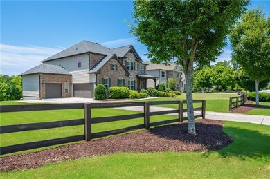 View of front facade featuring brick siding, an attached garage, and driveway