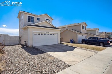 Traditional home with a garage, driveway, and fenc