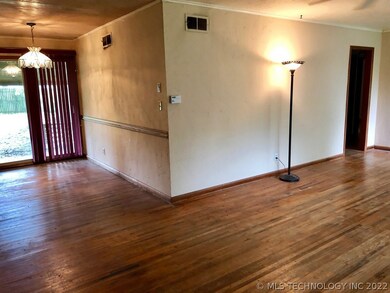 LIVING ROOM AND DINING AREA. ORIGINAL WOOD FLOORS.