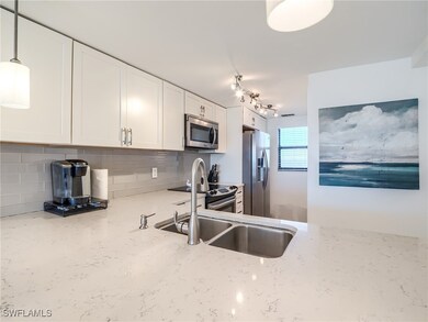 Kitchen featuring light stone counters, stainless