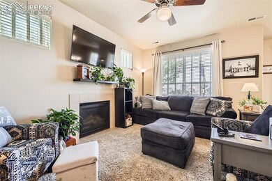 Living area featuring a tile fireplace and ceiling