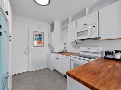 Kitchen featuring white appliances, light tile pat