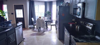 Kitchen with dark countertops, gray cabinets, a si