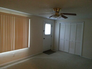 Spacious living room offers wall to wall carpet, c