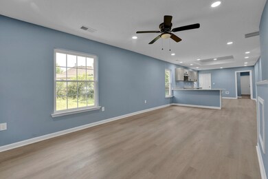 Unfurnished living room with ceiling fan, light wo