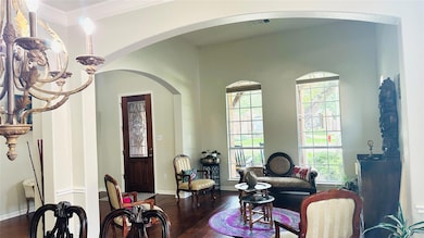 Living room with arched walkways, dark wood-type 