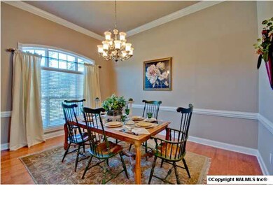 Enjoy family holiday dinners or entertain with elegance in this beautiful dining room with high ceilings, hardwoods, extensive moldings and views through the floor length windows.