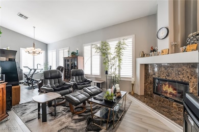 Living room featuring lofted ceiling, a high end f