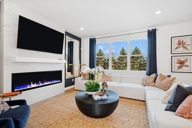 (Photo of a decorated model, actual homes finishes will vary) Cozy up next to the fireplace in your great room!