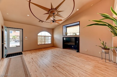 Foyer featuring lofted ceiling, wood finished floo