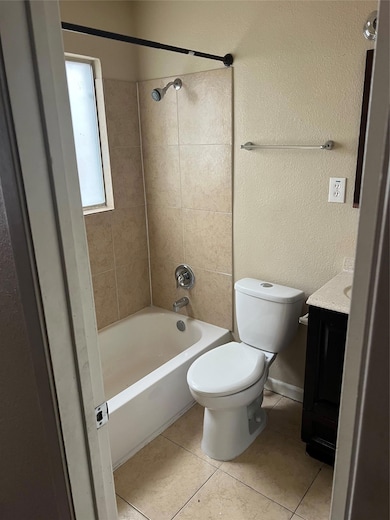 Bathroom with tile patterned flooring, vanity, to
