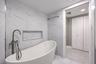 Bathroom featuring marble finish floor, visible ve