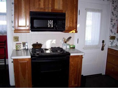 Kitchen. Gas oven/range & microwave on back wall o