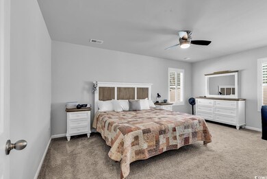 Bedroom featuring a ceiling fan, baseboards, visib