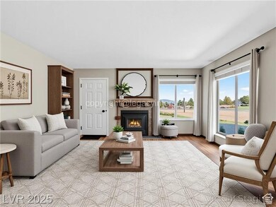 Living room with a warm lit fireplace and light wood-type flooring