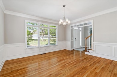 Spare room with a notable chandelier, visible vent
