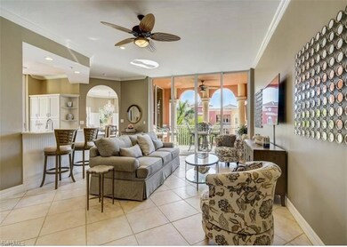 Tiled living room with ceiling fan and ornamental 