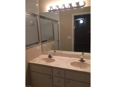 master bath with double sinks and large shower
