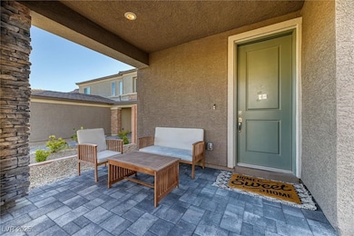 View of exterior entry with a patio and stucco siding