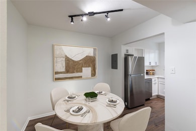 Dining room featuring dark wood-style floors, elec